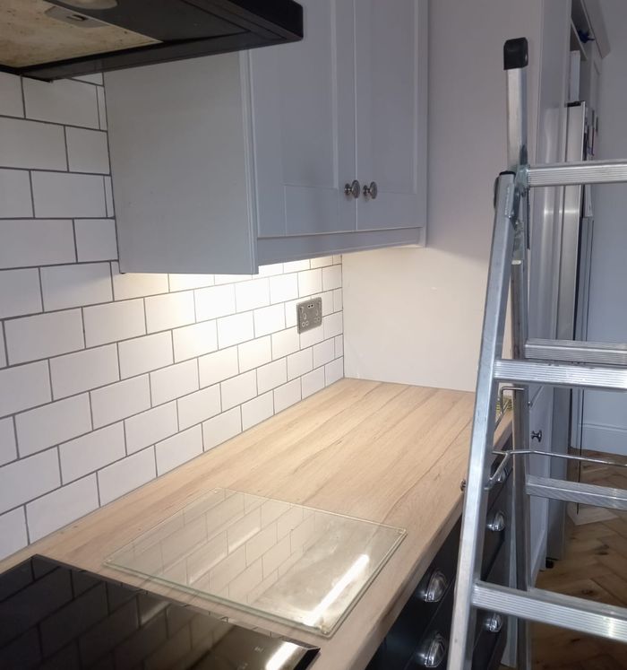 Sockets above a kitchen worktop under wall cabinets